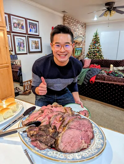 Smiling in front of holiday prime rib